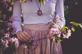 桜の枝をもつ女性